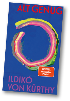 Das Buchcover zeigt den Titel Alt Genug in roten Gro buchstaben, darunter einen bunten, kreisf rmigen Pinselstrich und den Namen Ildik von K rthy in pinker Schrift auf blauem Hintergrund.  Beschreibung von KI generiert